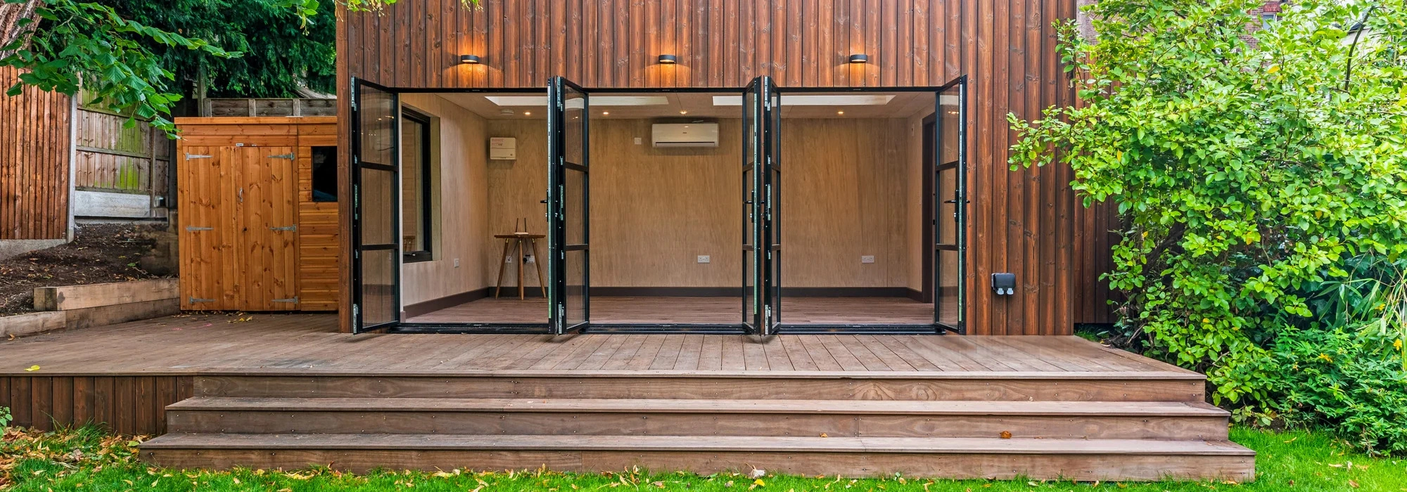 Contemporary garden annexe with timber cladding and large glazing suitable for Bedfordshire garden inspiration