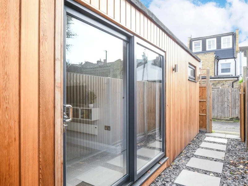Cedar clad one-bedroom garden annexe exterior with modern doors and compact footprint